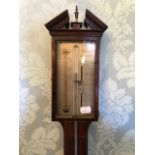 A 19th Century mahogany and strung mercury stick barometer, broken pediment with urn finial,