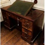 A George III mahogany kneehole writing desk, circa 1800,the centre with a leathered adjustable