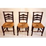 A set of six early 19th century elm rush seat farmhouse dining chairs, circa 1800, turned top rail