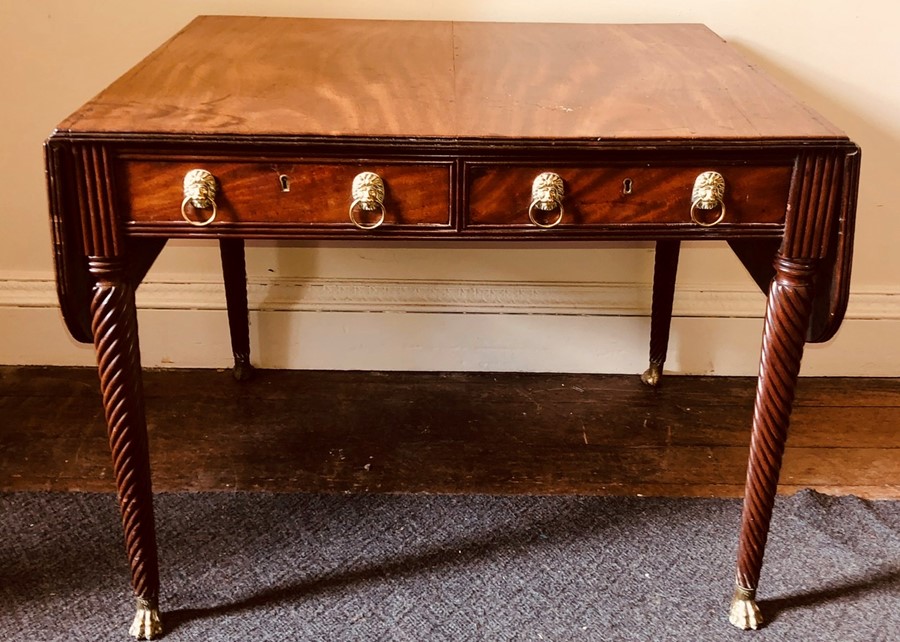 A George IV mahogany sofa table, circa 1825, rectangular top united with a pair of dropleaves each