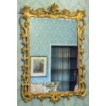 A George III gilt gesso wall looking glass, circa 1770, of Rococo design with chinoiserie