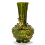 A Bretby art pottery green glazed vase with a well-modelled dragon wrapping around its
