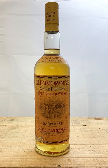 A bottle of 10 year old Glenmorangie single malt Highland whisky, a boxed bottle of Sake and several