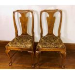 A pair of George I walnut chairs, circa 1730, each have a pierced urn splat back, raised on cabriole