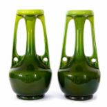 A pair of Bretby Art Pottery green glazed, twin-handled vases in the arts and crafts manner. No: