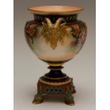 A Hadleys Worcester vase painted with fruit and leaves, with  gilded Rams head handles, standing