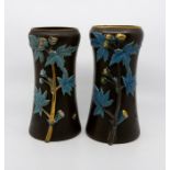 A pair of Aesthetic Movement black basalt tapered vases, circa 1880, relief moulded with with