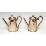A pair of 19th Century silver plated coffee pots, of oval tapered form, finials, scroll handles,