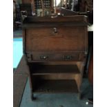 An early 20th Century oak bureau bookshelf, having a fall front over a single drawer, together