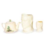 Three pieces of Bretby Art Pottery to include: an Edward VII musical mask-head jug, a smaller non-