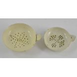 Two early nineteenth century creamware milseys or strainers, circa 1820. One is supported on three