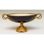 An late 19th Century pedestal centre bowl, two handled form, cobalt blue porcelain, ormolu handles