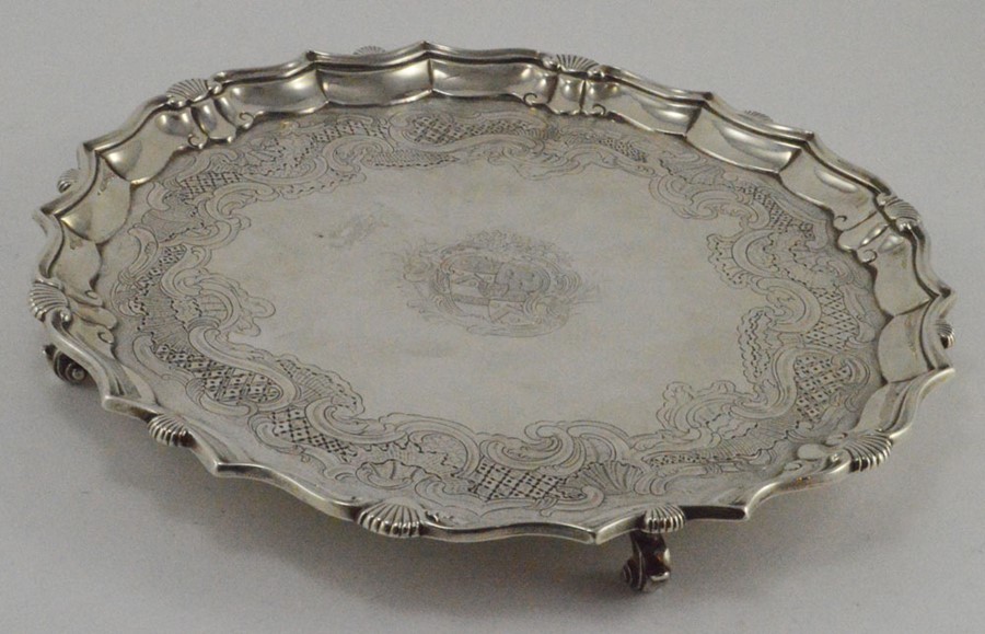 A George IV circular silver salver, pie crust border and shell border,  scroll engraved bed and