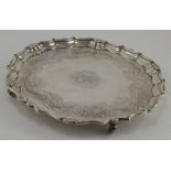 A George IV circular silver salver, pie crust border and shell border,  scroll engraved bed and