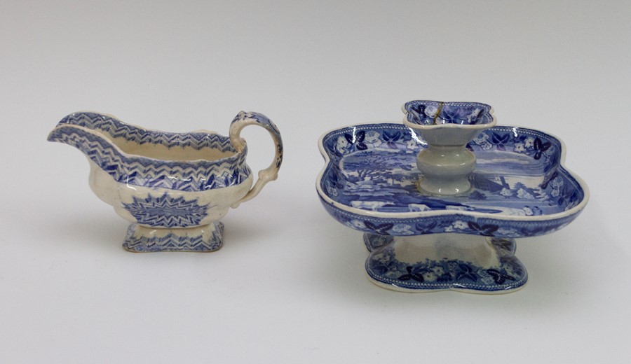 An early nineteenth century blue and white transfer printed pickle dish stand and a sauce boat,