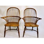 A pair of 19th Century elm and ash Windsor arm chairs, hooped back with curved arm rail on shepherds