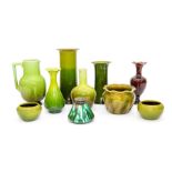 A group of Bretby Art Pottery vases, low dishes and a jug all decorated with green glazes,