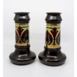 A pair of Bretby Art Pottery cylinder vases, stylized friezes with gilt detailing, No.1884, height