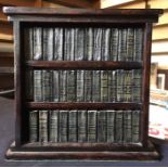 A miniature collection of William Shakespeare books, in book case