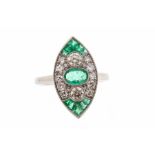 An emerald and diamond platinum set dress ring, marquise form set to the centre an oval emerald