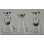 Three conical glass whisky noggins, all silver mounted, two with Whisky tickets, one marked