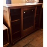 A 1970s teak framed bookcase, fitted with two glazed sliding doors