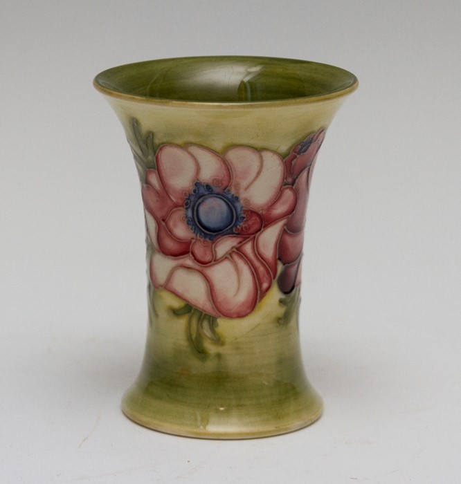 A Moorcroft tapered anemone vase, impressed marks and Queen Mary paper label, height 11cm