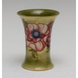 A Moorcroft tapered anemone vase, impressed marks and Queen Mary paper label, height 11cm