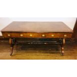 A regency revival mahogany library table, moulded edge rectangular top with octagonal corners,