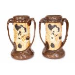 A pair of Bretby Art Pottery twin handled carved bamboo vases with oriental scenes, No. 1587
