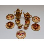 A collection of Royal Worcester miniature fruit painted tea/coffee wares, signed Roberts, to include