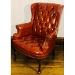 A Chippendale style Chesterfield wingback armchair, circa 1920, button back and seat with scrolled