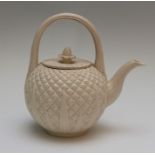 An eighteenth century salt-glazed stoneware teapot or punchpot moulded in the form of a pineapple,