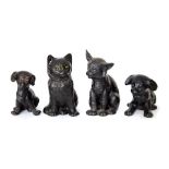 A group of Bretby art pottery black glazed animals including two cats and two puppies: Largest 19 cm