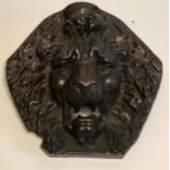 A 19th Century terracotta wall plaque of a Lion, pentagonal shape centred with a face of a Lion.
