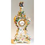 A Meissen porcelain eight day mantle clock, in the Rococo style, the white enamelled dial with Roman