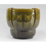 A Bretby Art Pottery green glazed jardiniere with moulded details in the arts and crafts manner. No: