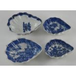 A group of four early nineteenth century blue and white transfer printed shell-shaped pickle dishes,