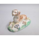 A Derby Rare Model of a Spaniel Date: circa 1759-60 Size: 9cm diameter, 5cm high. Condition: Some