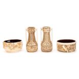 A pair of Bretby Art Pottery moulded ivory ground vases and two similarly moulded and decorated