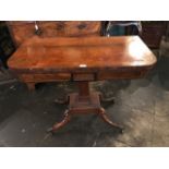 A George IV mahogany and brass inlaid card table, circa 1825,rounded rectangular folding top