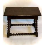 A late 17th Century walnut and oak stool, in Hispanic form, rectangular moulded edge, raised on