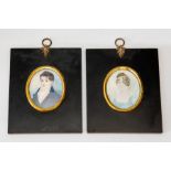 A pair of oval portrait miniatures on ivory, circa 1830, young gentleman wearing a blue tunic and