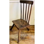 An 18th Century oak and elm child's chair, circa 1760, spindle back, raised on three turned legs.