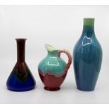 Three Bretby Art Pottery vessels, to include a conical vase with a metallic glaze, No.953C, a jug,