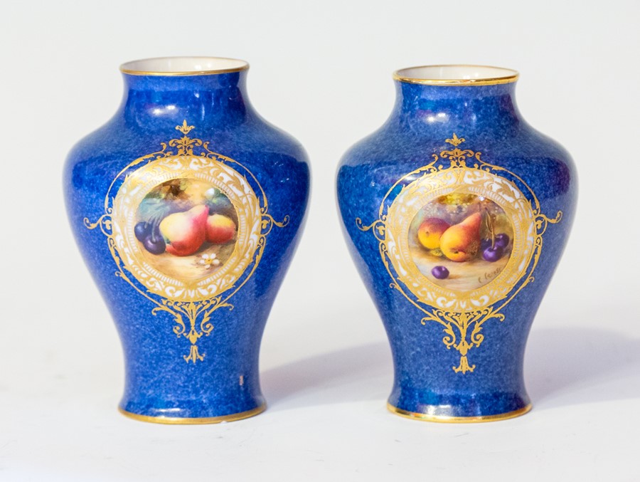 A pair of Royal Worcester vases, early 20th Century, of inverted baluster form, each with still life