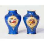 A pair of Royal Worcester vases, early 20th Century, of inverted baluster form, each with still life