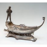 A WMF Art Nouveau pewter gondola, with a gondolier, clear glass liner, struck marks, width 55cm