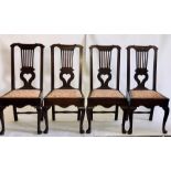 A set of four George III oak dining chairs, circa 1780, Chippendale form with a serpentine arch