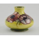 A Moorcroft hibiscus squat vase, impressed marks and Queen Mary paper label, height 11cm